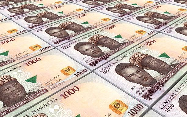 Stack of money symbolizing the financial aspect of healthcare decisions, highlighting the cost considerations for a DNA test in Nigeria.