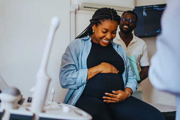 Pregnant patient arriving for a prenatal appointment, representing maternal care and raising awareness about options for a paternity test while pregnant.