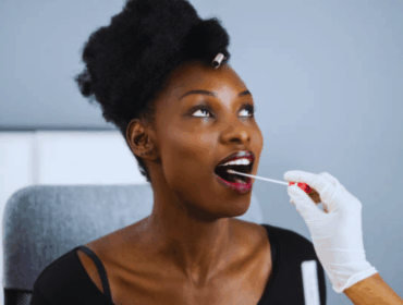 Close-up of a COVID-19 PCR swab test, illustrating medical sample collection procedures similar to those used in a DNA test for immigration.