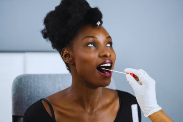 Close-up of a COVID-19 PCR swab test, illustrating medical sample collection procedures similar to those used in a DNA test for immigration.