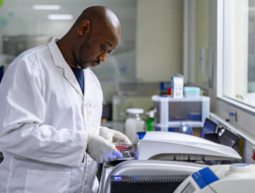 Lab technician working with precision in a state-of-the-art bioscience laboratory, representing scientific responsibility, healthcare innovation, and discussions around genetic screening ethics.