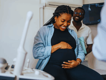 Pregnant patient arriving for a prenatal appointment, representing maternal care and raising awareness about options for a paternity test while pregnant.